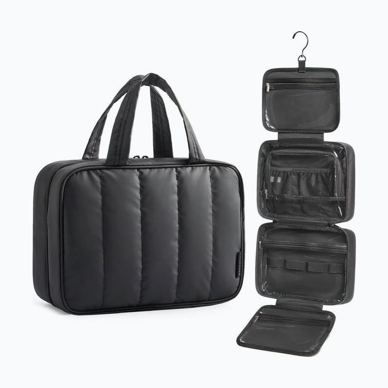 Black quilted toiletry bag, open and hanging from its hook