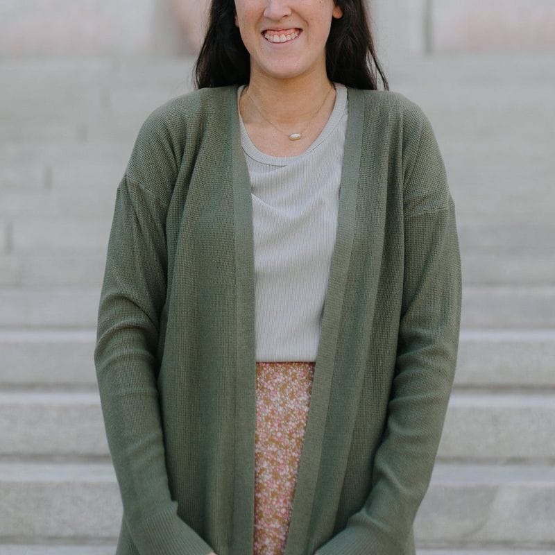 Long olive-green open cardigan over a gray T-shirt