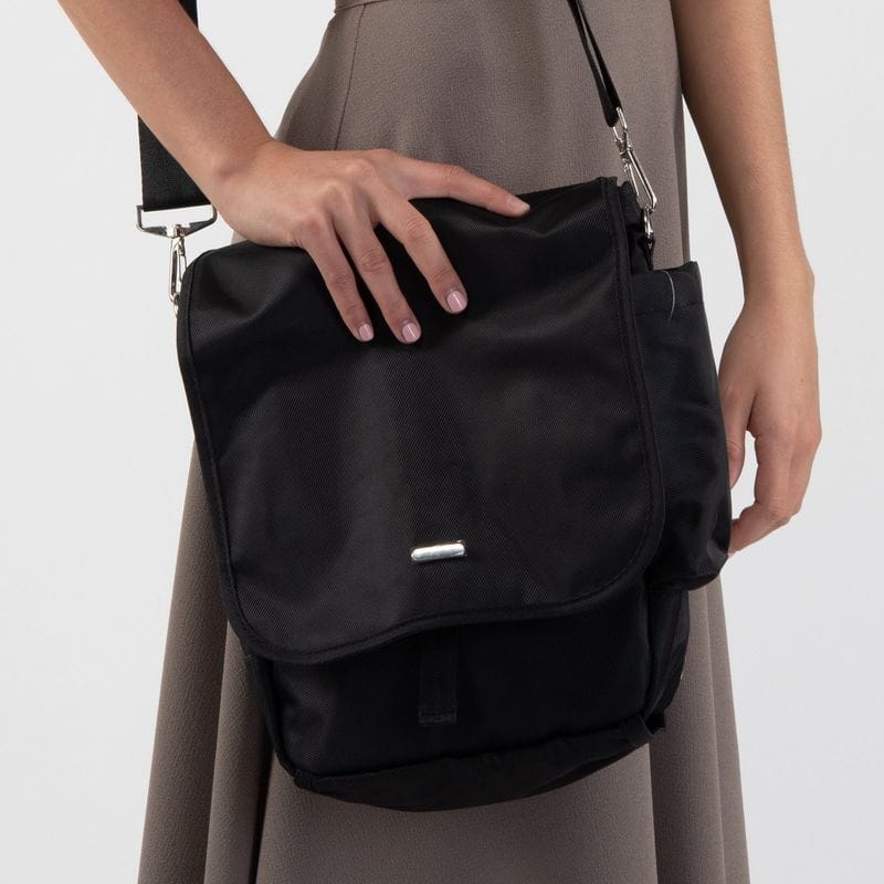 Black nylon messenger bag worn across the body